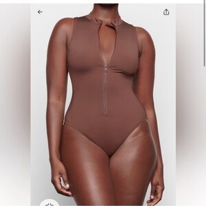 Skims one piece zipper bathing suit